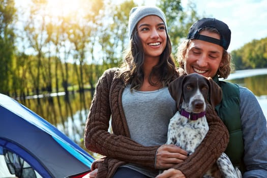 Practice a nature friendly lifestyle. a loving couple out camping with their dog