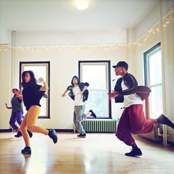 Practice makes a performance. a group of young people dancing together in a studio
