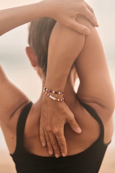 Beautiful girl doing yoga at the beach. High quality photo