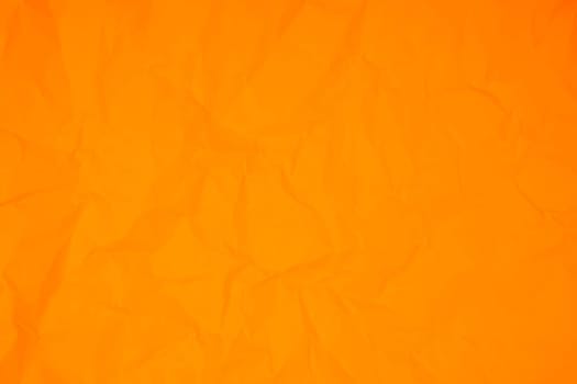 Orange color crumpled paper texture background