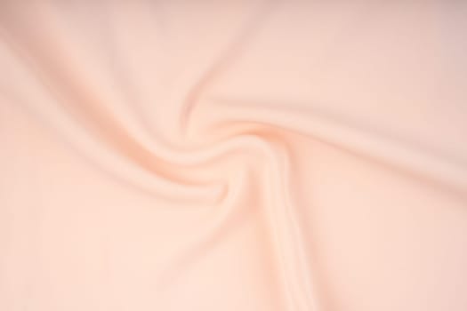 Texture of the satin fabric of beige color for the background
