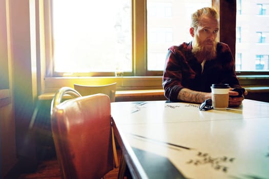 Sitting cool in the coffee shop. a male hipster in a coffee shop