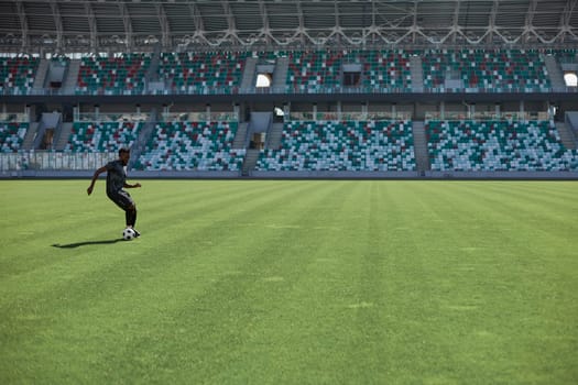 Professional football player in action at the stadium. The concept of sport, competition, movement, overcoming. The effect of the presence of the field.