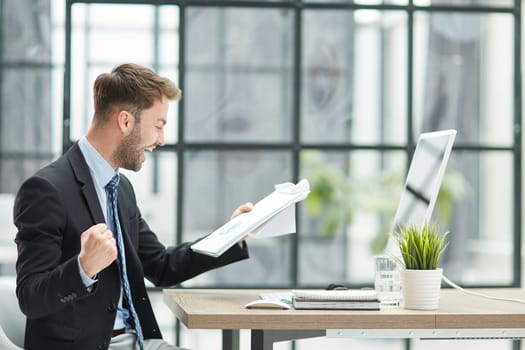 energetic businessman celebrating in office