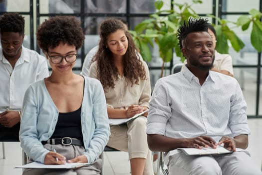 a group of people at a lecture listening attentively to the speaker