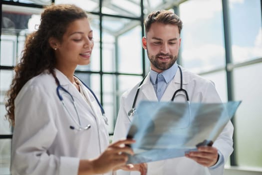 Concentrated male doctor looking at x-ray picture of spine