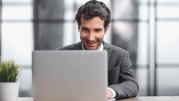Successful businessman working inside office, man in business suit working at workplace with documents and laptop