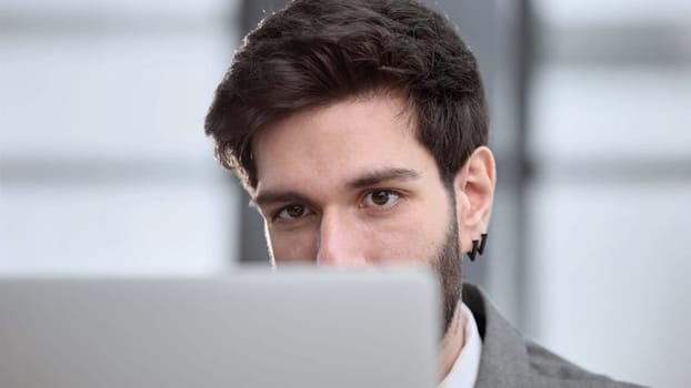 focused young businessman looking at computer monitor