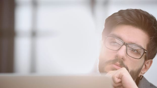 focused young businessman looking at computer monitor