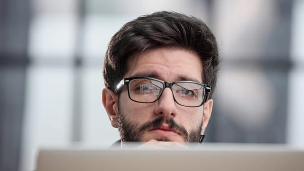 focused young businessman looking at computer monitor
