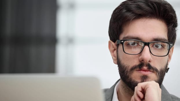 focused young businessman looking at computer monitor