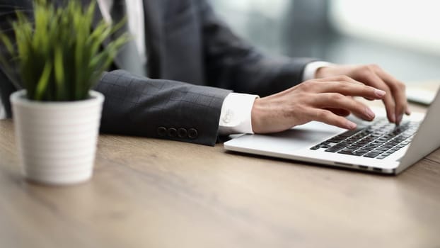 man working at home office hand on keyboard close up