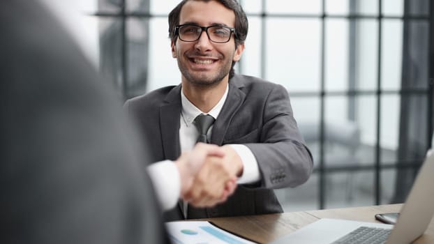 handshake of business partners at a meeting in the office