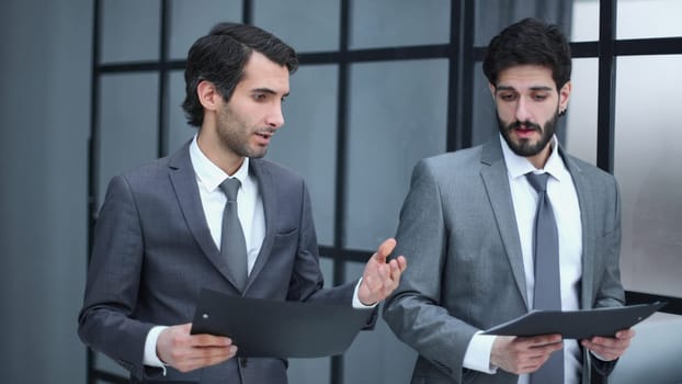 wo successful businesspeople while standing near office building