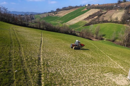 farmer driving uphill crawled tractor in the farm during spring season