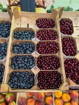 Fresh fruits lie in cardboard boxes in boxes on the counter in the market. High quality photo