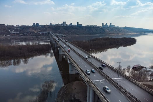 A road bridge over the river, taken from a quadrocopter. Urban traffic.