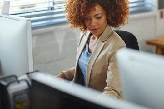 Working hard. a beautiful young businesswoman sitting in her office