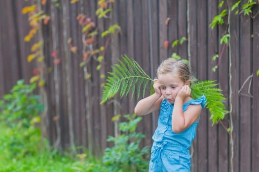 child girl dancing in the field park. happy childhood a family friendship concept. girl kid whirls in a blue dress in grass in the summer park. daughter in dancing whirls in the summer in nature sun