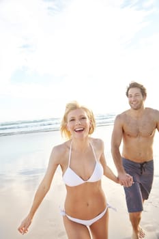 Romance and fun in the sun. an attractive young couple walking on the beach