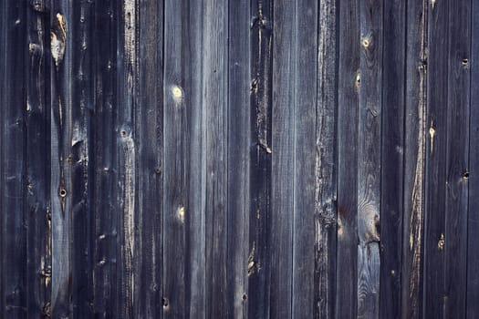 Gray wood paneling of the barn walls with a wide texture. Old solid wood sluts on a rustic shabby gray background.Old vintage background with wood texture