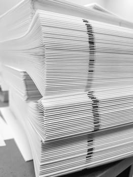 A stack of blank paper, book blocks prepared for binding in a printing house.
