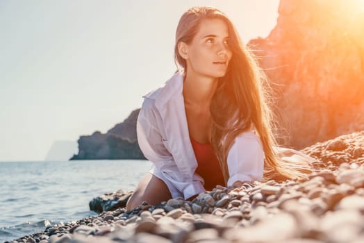 Sexy young woman in stylish bikini lying on seashore, closeup. Holiday, vacation and recreational concept.