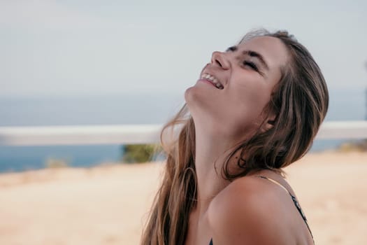 Happy woman portrait in cafe. Boho chic fashion style. Outdoor photo of young happy woman with long hair, sunny weather outdoors sitting in modern cafe