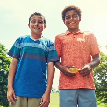 Almost time for water balloon fun. Portrait of adorable young boys outdoors