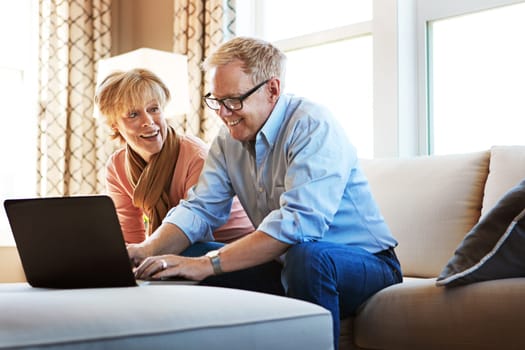 Technology is so much easier than I thought. a mature couple using a laptop together at home on the sofa