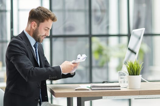 Businessman Taking Papers From Secretary In Office