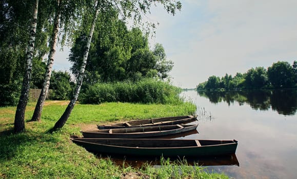 Eastern Europe, Republic of Belarus, Kachanovichi village, Pinsk district, Brest region. River and boats in the summer season.