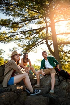 The sun shines on those who let it. three young people hiking while on an overseas trip