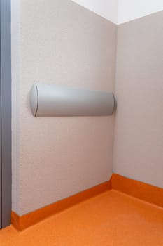 On the wall of the corridor installed plastic wall bumper. Protecting the wall from mechanical damage.
