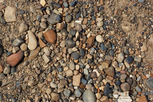 Texture; top view of the laid out of small and large stones and sand