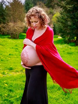 Young beautiful woman with pregnant belly showing.