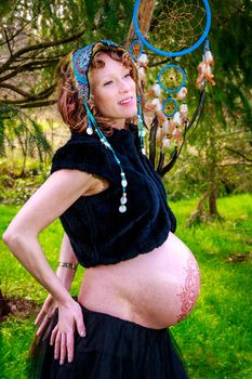 Young beautiful woman with pregnant belly showing.