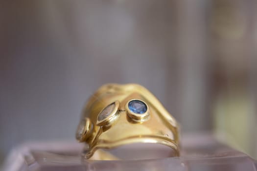 gold ring with precious stones view through glasses