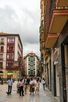 Bilbao, Basque Country, Spain - 10.06.2022: People stroll through the narrow streets of Bilbao