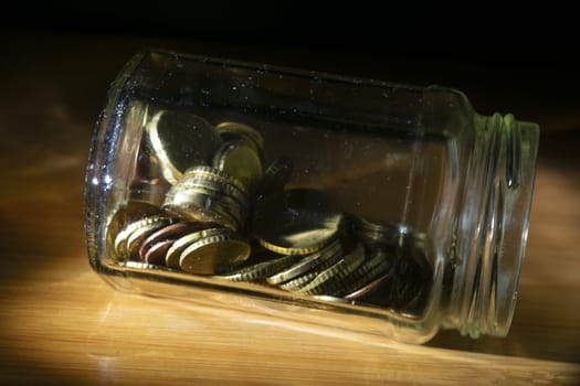 glass jar full of coins for savings concept