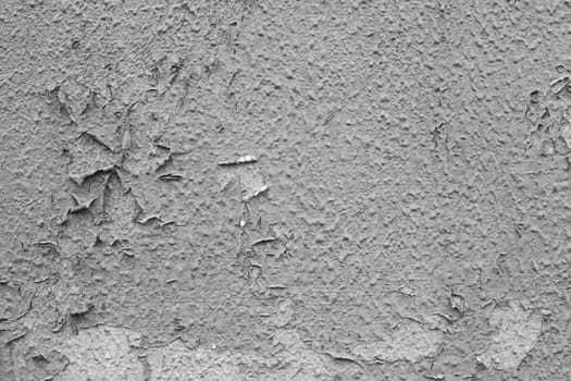 Design pattern, wall texture, plaster background. Texture of peeling old gray paint on the wall.