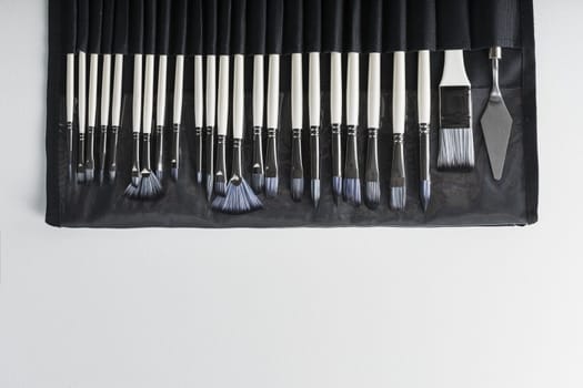 A set of art brushes for drawing on a white background, top view with free space