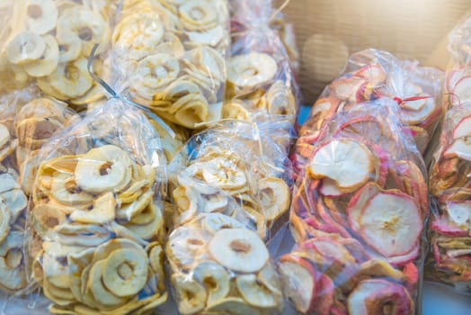 Preparation of dried fruits. Slices of dried apples are laid out in plastic bags. Eating dried fruits in winter. High quality photo