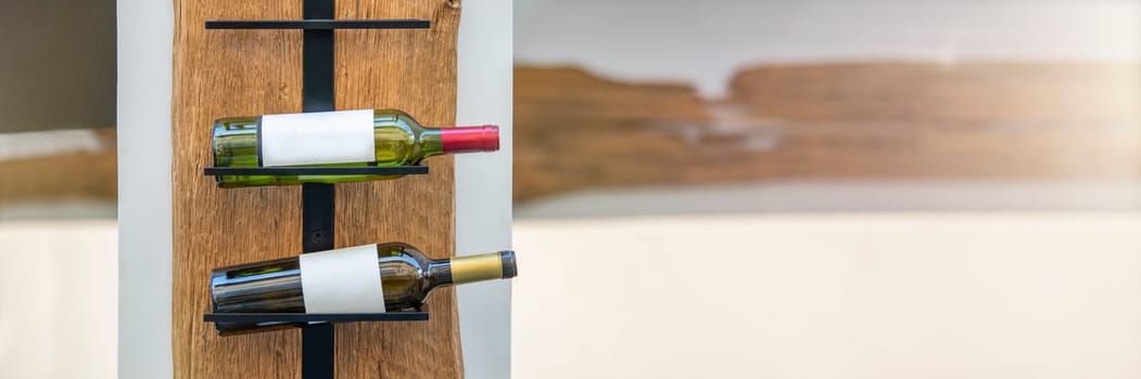 Wine storage holder made of wood and metal rustic style. Wine bottles are arranged on a holder with copy space. The concept of collecting alcoholic beverages. High quality photo