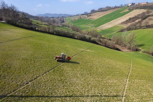 farmer driving uphill crawled tractor in the farm during spring season