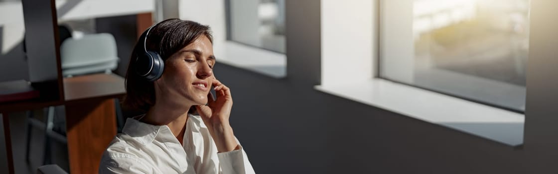 Attractive european business woman working laptop while sitting in cozy cafe. Blurred background