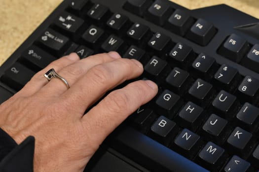 Female Left Hand Typing on Computer Keyboard. High quality photo