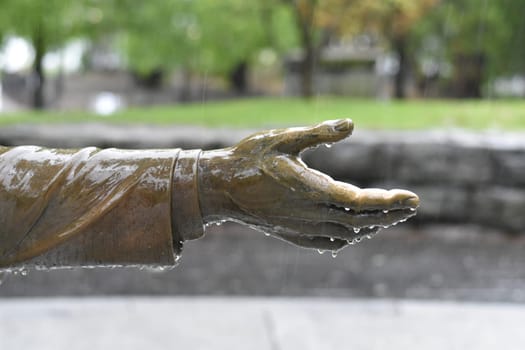 Hand of Statue Dripping Raindrops on a Wet Rainy Day. High quality photo
