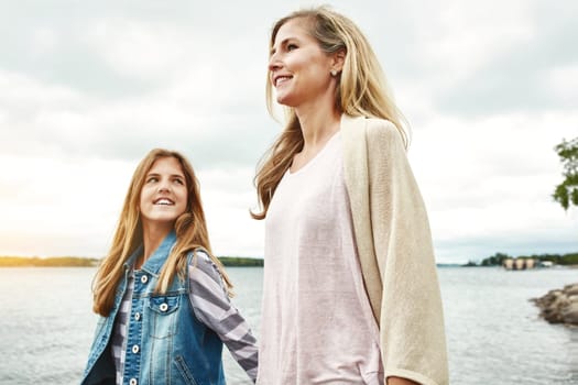 She loves being out and about with Mom. a mother and her daughter bonding outdoors