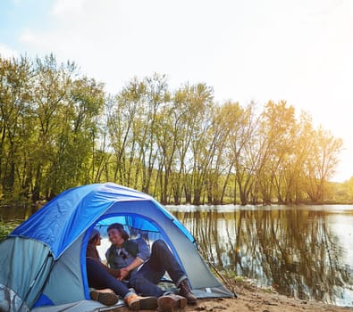 Create some camping romance in your life. an adventurous young couple at their campsite